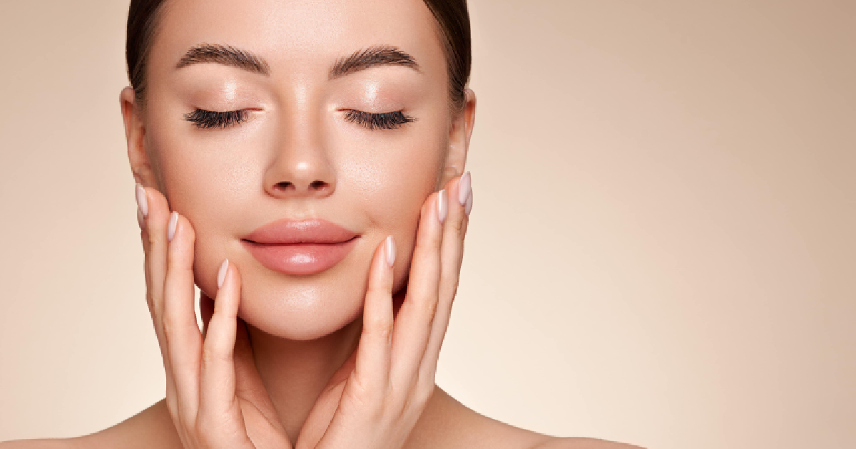 Woman with smooth, glowing skin gently touching her face, after RF Microneedling Treatment in Morristown, NJ.